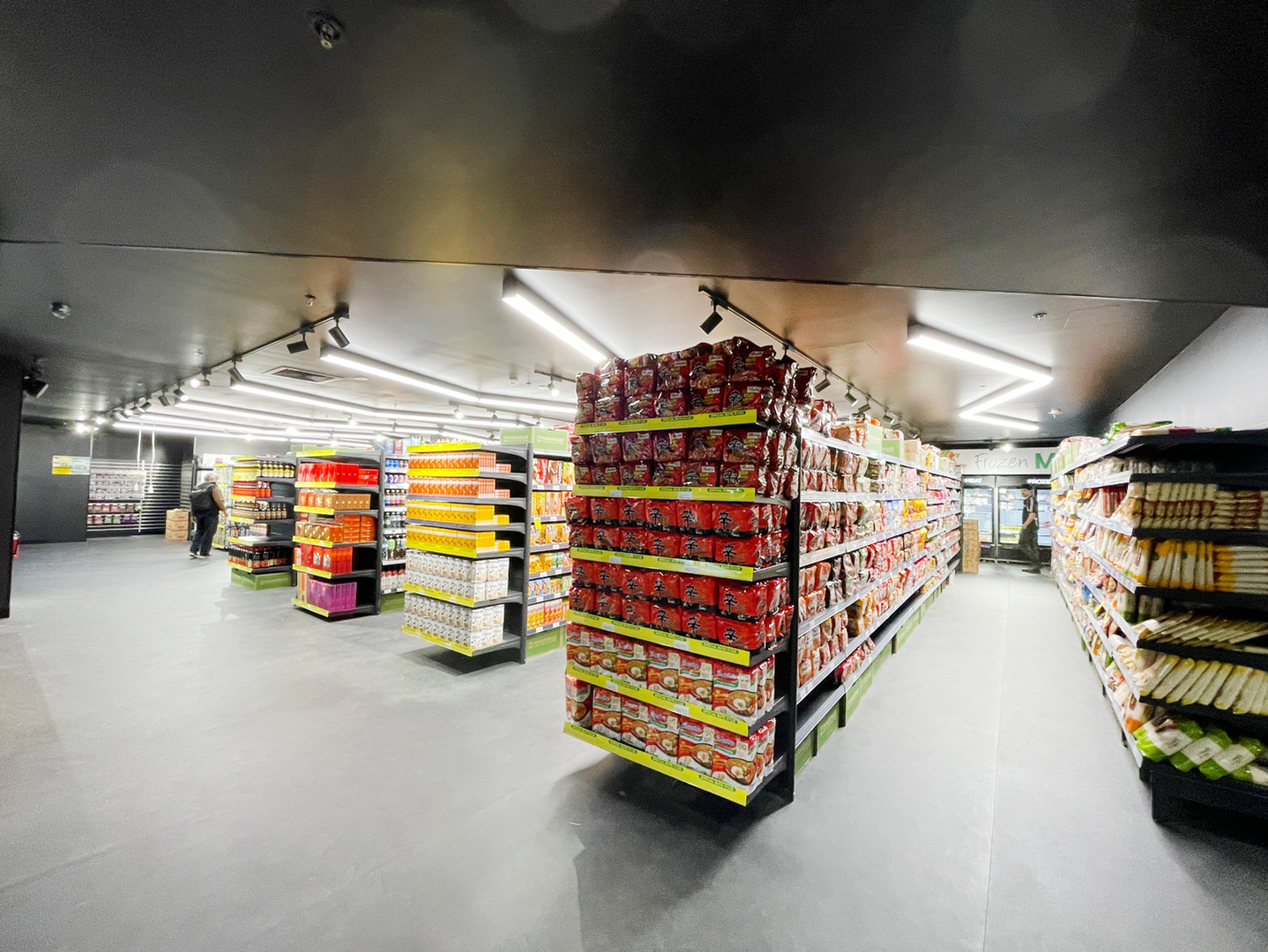 Wide grocery aisle stocked with Korean and Asian pantry staples